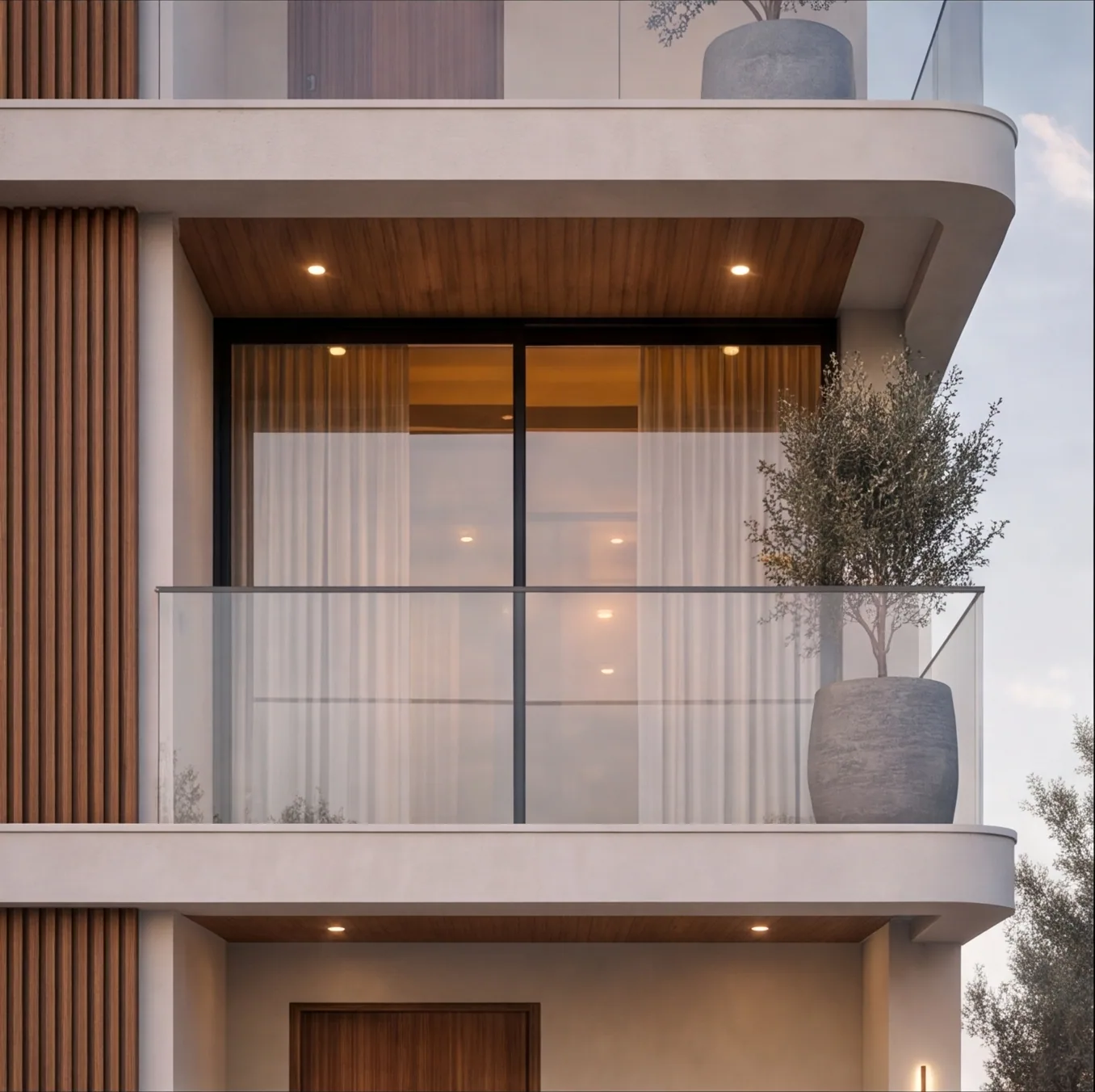 Close view of a balcony with sliding glass doors, sheer curtains and a potted olive tree